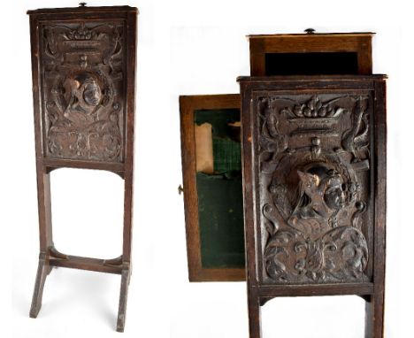 A 19th century adjustable oak fire screen, the oak frame with an ornately carved panel with a protruding bust of Hermes shown