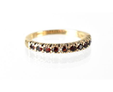 A 9ct gold and ruby half eternity ring, set with ten small rubies, size Q, approx 2.6g. CONDITION REPORT Scratches to shank, 