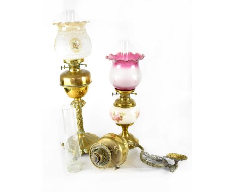 A Victorian brass oil lamp with later moulded and printed shade, the whole on a lobed base with four claw feet, height 74cm, 