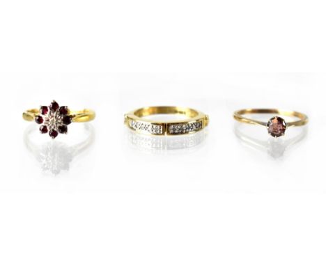 An 18ct gold ruby and illusion-set diamond cluster ring, size O, a 9ct gold claw-set pink stone ring, size P and a modern hal