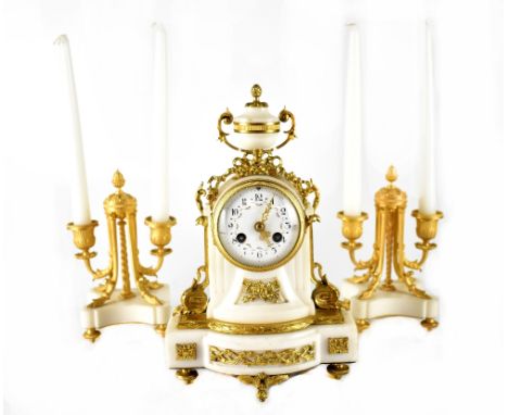 An Empire-style alabaster and gilt metal clock garniture, the clock with painted enamelled dial set with Roman numerals enclo