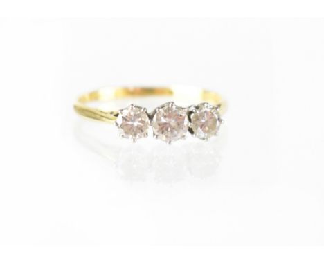 A Boodle &amp; Dunthorne 18ct yellow gold and platinum three-stone diamond ring, size T, approx 2.7g. CONDITION REPORT Clear 