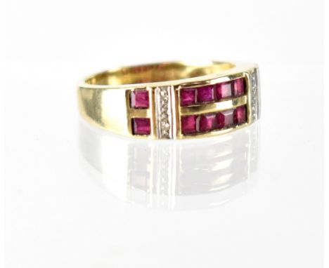 A modern 9ct gold ruby and diamond ring, two rows of six small square-cut rubies separated by two columns of tiny diamond chi