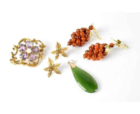 A 9ct gold brooch with amethyst and pearl flower on open scroll mount, a green jade pear drop necklace with 9ct gold mount, a
