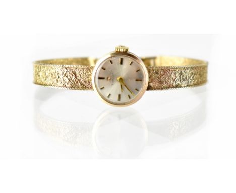 Tissot; a ladies' vintage 9ct gold wristwatch, the circular silvered dial set with raised baton markers and crown wound movem