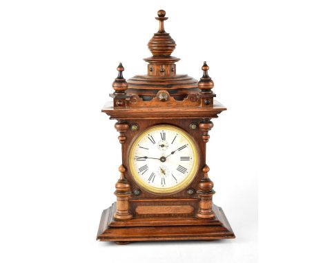 An early 20th century oak-cased mantel clock, the painted dial set with Roman numerals and subsidiary dials, enclosing a move