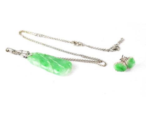 A 9ct white gold jade-set pendant and a pair of oval jade stud earrings. CONDITION REPORT The pendant is approx 3.5cm long, t