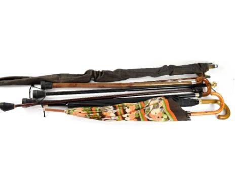 A group of four late 19th/early 20th century walking canes to include an example with a 9ct gold top, an example with carved 