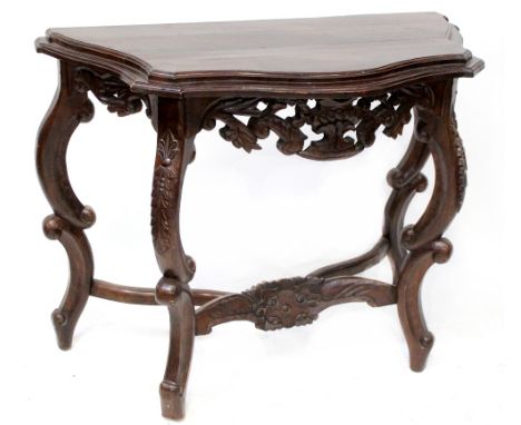 A reproduction hardwood console table, serpentine top on C-scroll and heavily carved base, height 80cm, width 106cm, depth 49