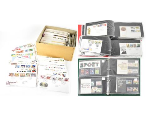 A quantity of presentation packs in three folders and a quantity of first day covers.