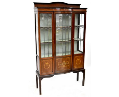 An Edwardian mahogany inlaid display cabinet, central bow front astragal glazed door, three interior shelves above one centra