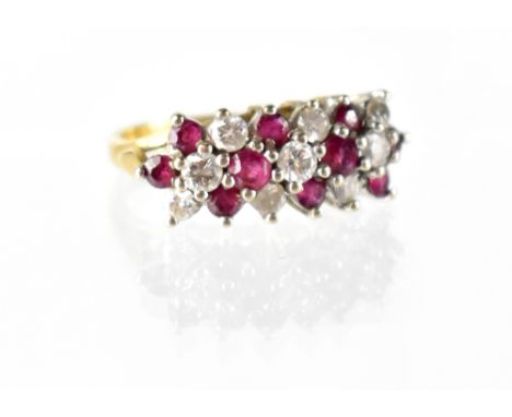 An 18ct gold diamond and ruby ring, the ring has three lines of claw-set small brilliant diamonds and rubies, size M, approx 