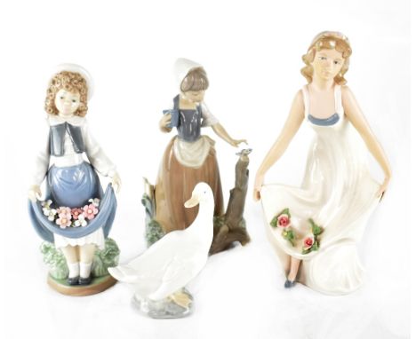 Three Nao figures to include a young girl with flowers in her skirt, a young girl with butterfly and a goose, also a D'avila 