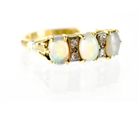 A 9ct gold three-opal ring with two columns of two tiny diamonds in between, size N, approx 3.4g. CONDITION REPORT Partial ha