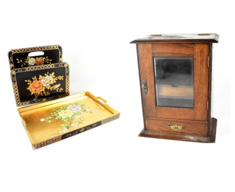 A c1940s oak smoker's cabinet, hinged lift-up top above glazed door, interior with pipe rack, etc, lacking tobacco jar, 41 x 