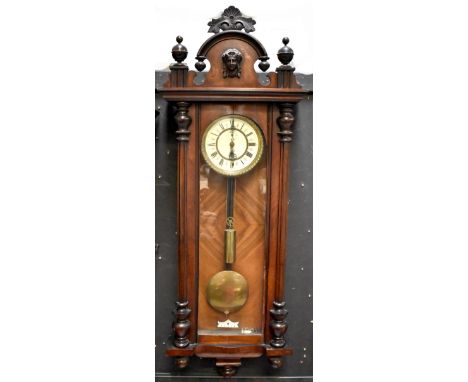 A 19th century Vienna-style mahogany wall clock, c1980, curved pediment top with raised female head decoration above an ename