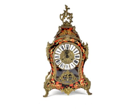 A reproduction brass-mounted bombé-shaped boule type mantel clock, the brass dial set with enamelled panels bearing Roman num