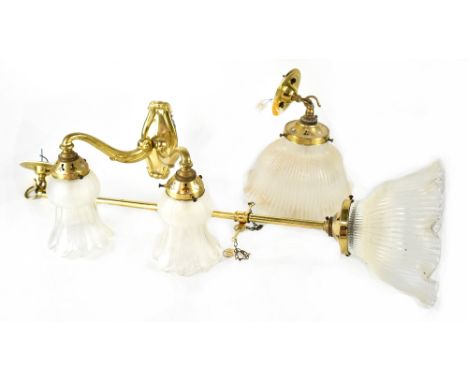 Various lighting to include twin-branch gilt metal wall sconces with matching single-branch wall sconces, one other on an oak