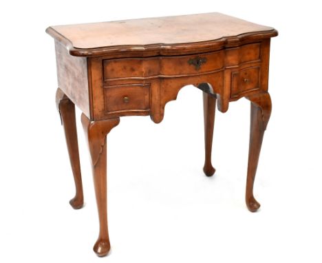 An 18th century style walnut lowboy with bow front, with three drawers, on carved cabriole legs, height 75cm, width 76cm, dep