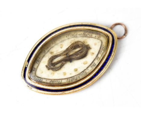 An 18th century mourning pendant, a bow of hair on an oval ivory back surrounded with words that appear to read 'This is the 