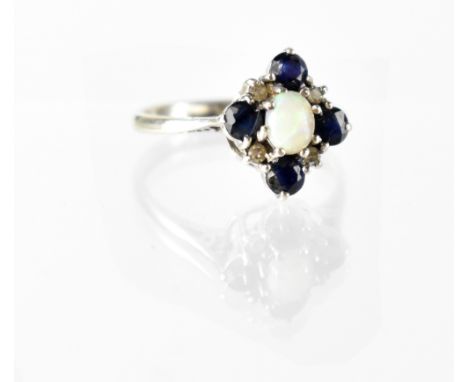 A 9ct white gold opal, diamond and sapphire cluster ring, size N, approx 2.4g. CONDITION REPORT Hallmarked.