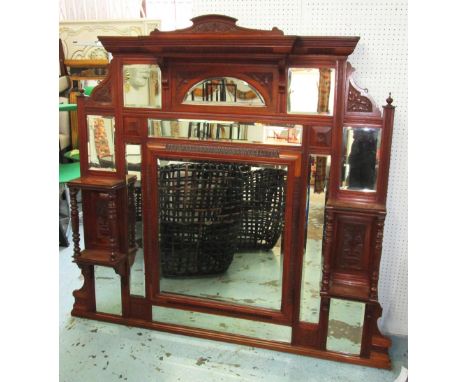 OVERMANTEL, Edwardian walnut, with bevelled plate and cushion centre mirror in an ornate carved frame, 150cm x 163cm. (with s