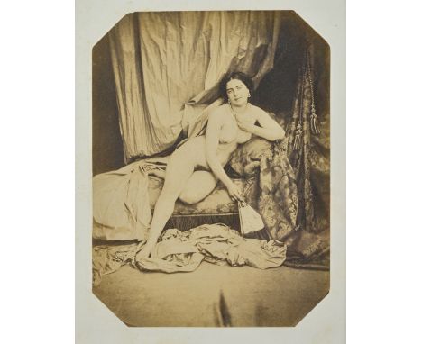 AUGUSTE BELLOC  (1800 - 1867)  
Reclining female nude on chaise longue, ca, 1855.  salt print, mounted on card, 20.7cm x 15.5