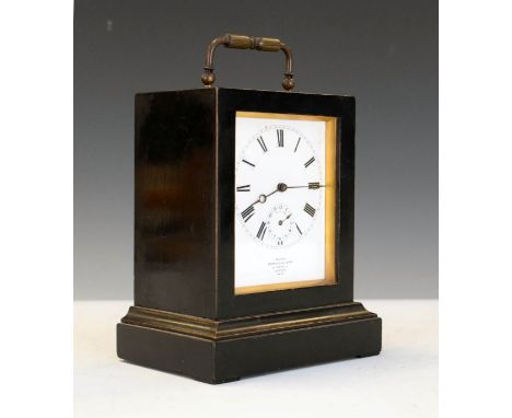 Late 19th/early 20th Century French ebonised cased carriage clock having a brass folding handle to the top, white enamel dial