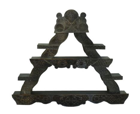 Early 20th Century Danish carved wall shelf of triangular form, probably Amager, having two long and four short shelves, carv