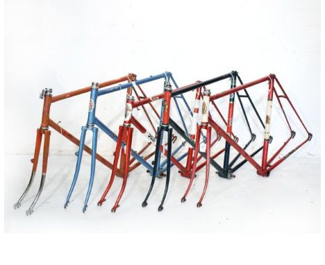 Vintage racing cycle frames comprising: Two Claude Butler frames in green and metallic red respectively, a Sun frame in red a