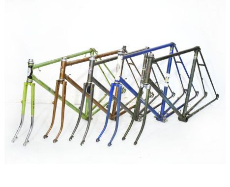 Vintage racing cycle frames comprising: Carlton frames in light green and blue respectively, a Claude Butler frame having met