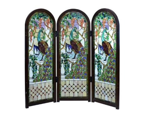 Reproduction three fold arch top leaded glass screen, the panels depicting peacocks at a window with grapevine surround, 158c
