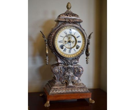 Ornate cast metal mantel clock, the off-white dial inscribed Ansonia Clock Company, overall height 45cm   Condition: 