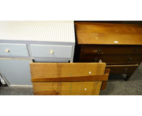 An early 20th Century oak chest of three long drawers, shaped bracket feet; a painted kitchen cupboard, two short drawers abo