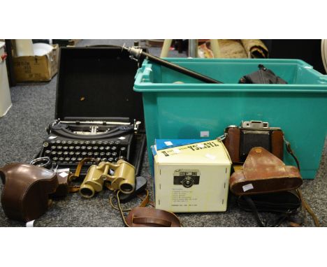 A Patria cased typewriter; binoculars, painted sand coloured; a Pentax camera; tripods; an Agifold range finder; Yashica came