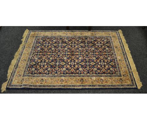 A Middle-Eastern rug, in tones of dark blue, cream and peach melba, 170 cm x 116 cm
