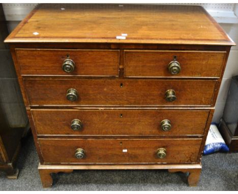 A George III oak campaign chest of two short cock beaded drawers above three long conforming drawers, shaped bracket feet.