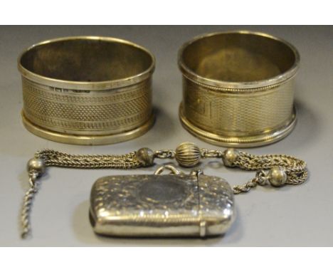 Silver - an Edwardian silver vesta case, Birmingham 1903, with chain;  a silver engine turned oval napkin ring;  another, 69.