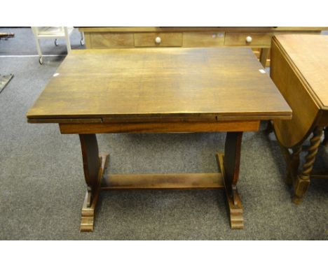 An early 20th Century oak and mahogany draw leaf dining table, fluted lyre shaped supports, stepped bracket feet, refectory s