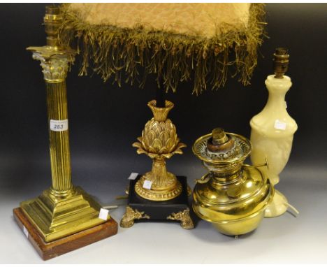 A brass Corinthian column table lamp, wooden base;an ornate gilded pineapple column table lamp; onyx lamp; a brass oil lanter