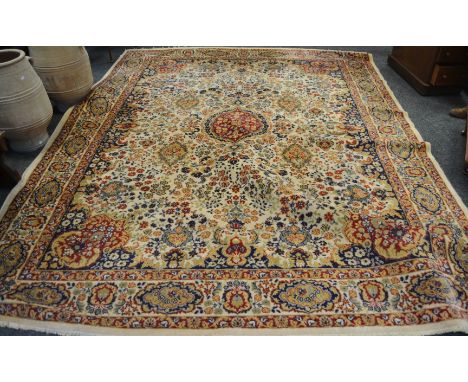 A Kashmiri wool and silk blend carpet in tones of terracotta and Royal blue on a taupe ground, 340cm x 260cm 