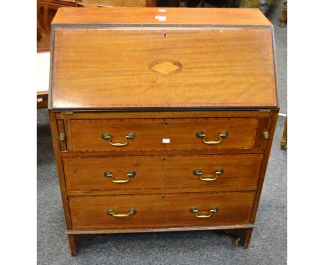 A  mahogany Sheraton Revival  bureau, the fall front inlaid with central oval shell patera surrounded by an ebony and satinwo