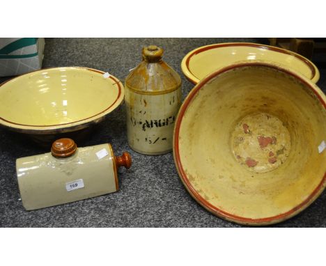 A stoneware foot warmer; a stoneware Flagon with R J Stokes and Co Sheffield label applied; three terracotta pancheon bowls ;