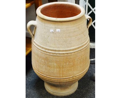 A substantial terracotta twin handled baluster shaped planter