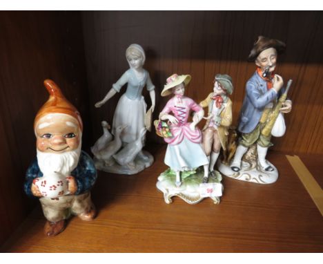 FOUR CERAMIC AND PORCELAIN FIGURINES INCLUDING FIGURAL GROUP AND LLADRO STYLE GIRL WITH DUCKS.