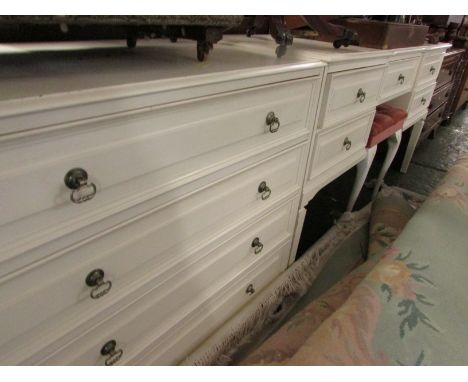 CREAM MELAMINE DRESSING TABLE WITH THREE-PART MIRROR, STOOL AND CHEST OF FOUR DRAWERS.