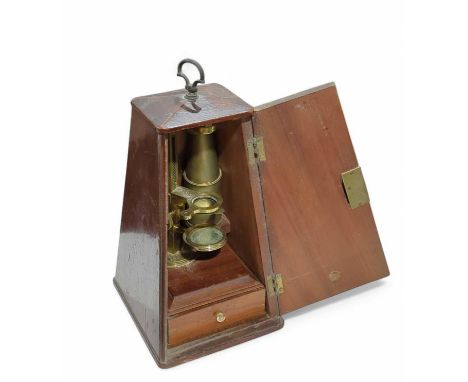 A brass microscope contained in a metronome-style mahogany case. The microscope in two pieces, accompanied by a selection of 