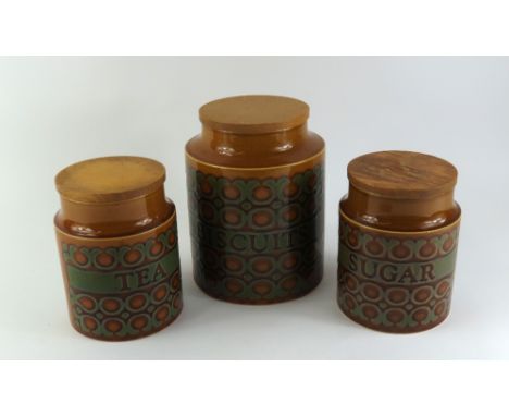 Three Hornsea pottery jars with glossed patterns and text assigning the jars to hold tea, biscuits and sugar. Each of a syrup