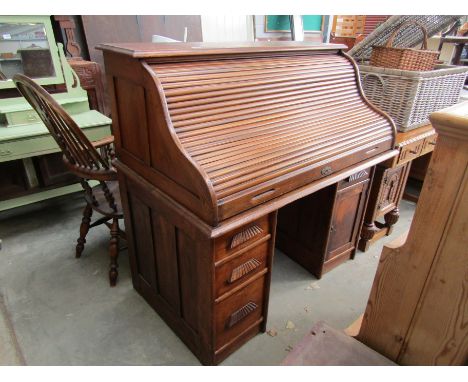 An early 20th Century tambour top twin pedestal desk with keys