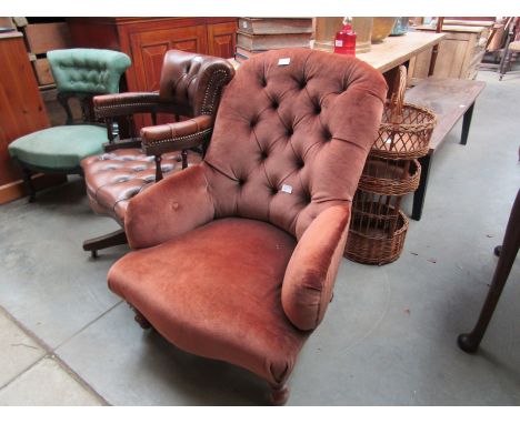 A Victorian button back armchair 